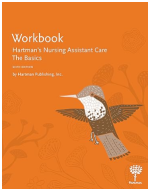 Cover of the workbook “Hartman’s Nursing Assistant Care: The Basics” by Hartman Publishing, featuring an illustrated hummingbird in neutral tones on an orange background with subtle floral line art.