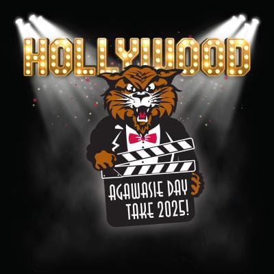 Illustration of a wildcat mascot in a tuxedo holding a movie clapperboard that reads “Agawasie Day Take 2025!” beneath a marquee-style “HOLLYWOOD” sign with spotlights and a black background.